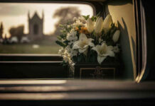 White flowers in a car with blurred background.