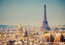 Minister Demands Three-Year Immigration PAUSE! A panoramic view of Paris featuring the Eiffel Tower and a golden dome