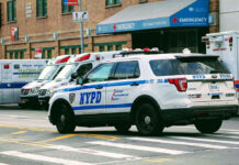 Another DEATH As Destructive Title Celebrations Continue! Police car and ambulances outside emergency room entrance.