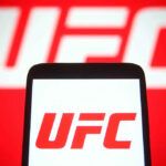 Patriotic Fighter Drops EPIC One Liner During White House Event! UFC logo on phone screen and background.