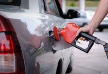 A person refueling a car at a gas station