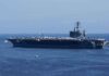 A large aircraft carrier sailing in the ocean