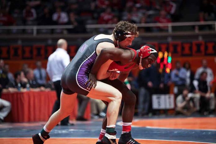 shutterstock_135776582 Two wrestlers competing on a mat during a match