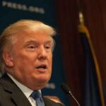Trump’s OBSESSED With Buying These Trees! – Why? A public figure speaking at a podium during a press conference
