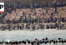 Visa Showdown: Italy Slams Door on Neighbors Thousands of migrants swim around the border from Morocco into Ceuta, Spain