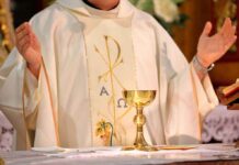 Priest’s Chapel Horror Stuns Investigators A priest holding a golden chalice during a religious ceremony
