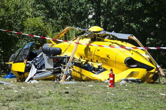 yellow helicopter crash scene on grassy field