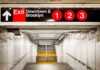 Train Brawl Turns Deadly – 2 Men AMBUSH Passenger Subway exit sign indicating Downtown and Brooklyn with train numbers 1, 2, and 3