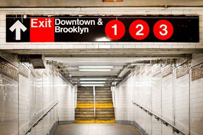 New,York,City,Subway,Passageway,And,Sign,To,Brooklyn Subway exit sign indicating Downtown and Brooklyn with train numbers 1, 2, and 3