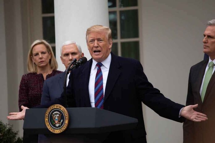 man speaking at podium with officials standing behind