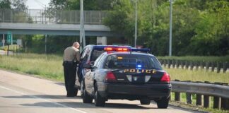 Police officer conducting a traffic stop on a highway
