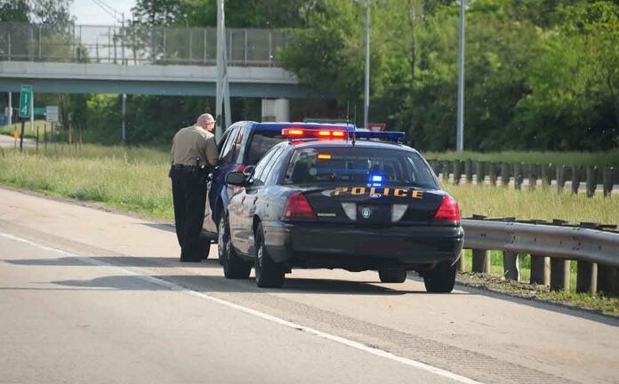 shutterstock_12763549-2 Police officer conducting a traffic stop on a highway
