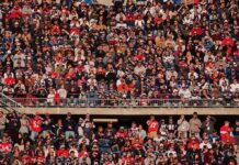 Crowd of fans filling stadium seats