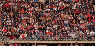 Crowd of fans filling stadium seats