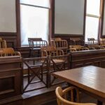 Empty jury box in a courtroom with wooden chairs