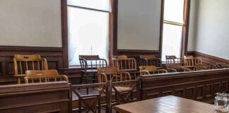 Empty jury box in a courtroom with wooden chairs