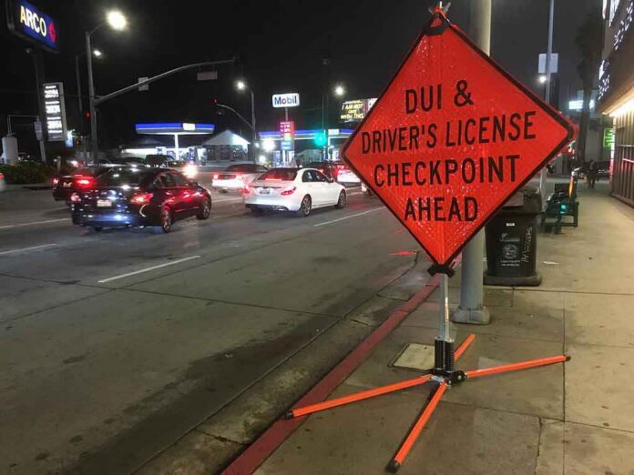 Traffic checkpoint warning sign on city street at night
