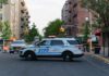 Gang Crossfire Kills Cop’s Son NYPD police SUV blocking a city street at a taped-off scene