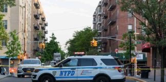 NYPD police SUV blocking a city street at a taped-off scene