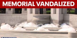 WWII Memorial fountain overflows with bubbles, vandalized with paint