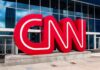 CNN red logo sculpture outside a modern glass building