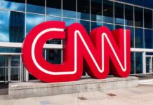 CNN red logo sculpture outside a modern glass building