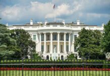 The White House north facade behind a black iron fence