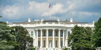 The White House north facade behind a black iron fence