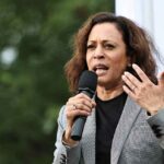 woman speaking into a microphone at an outdoor event