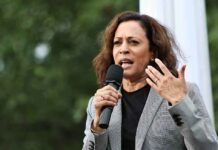 woman speaking into a microphone at an outdoor event