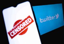 smartphone showing censored stamp beside twitter logo