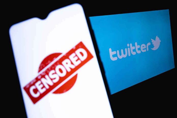 shutterstock_1968572158 smartphone showing censored stamp beside twitter logo