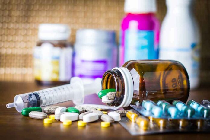 Medicine pills and syringe on table with brown bottle