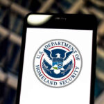 DHS Demands NFL Pulls Controversial Border Video U.S. Department of Homeland Security logo on smartphone.