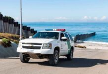 Illegals Find Out It’s Not a Good Idea to Enter Country on Jet Skis Border patrol SUV parked near beach fence