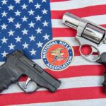 Woke State’s New Gun Permit System Is Insane Two handguns and NRA emblem on an American flag