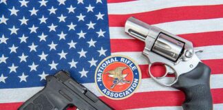 Two handguns and NRA emblem on an American flag