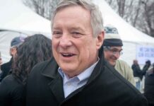 older man smiling at an outdoor event