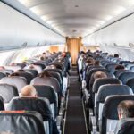 Airplane Cabin CHAOS, Roof Collapses Mid-Flight Airplane cabin with passengers seated in rows