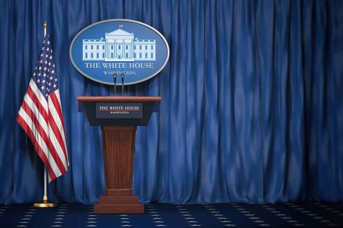 White House press briefing podium with U.S. flag and blue curtain
