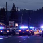 5 Women DEAD – Chilling House Of Horrors Exposed Police cars with flashing lights block a road at night