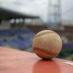 Baseball resting on a dugout rail