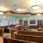 Empty courtroom with wooden benches and judge's bench