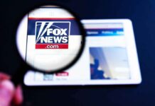 Fox New Hires Cuomo Aide – Backlash Erupts Magnifying glass over Fox News website logo on a tablet