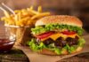 Cheeseburger with fries on rustic surface