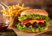 Cheeseburger with fries on rustic surface
