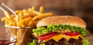 Cheeseburger with fries on rustic surface