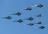 A formation of military jet fighters flying in a clear blue sky