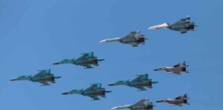 A formation of military jet fighters flying in a clear blue sky