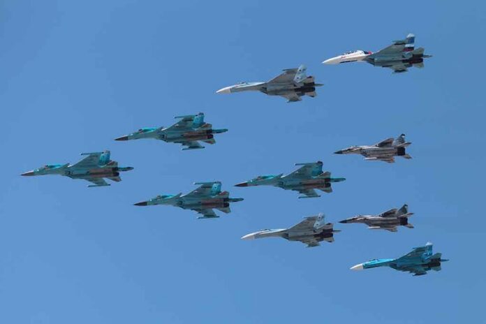 shutterstock_141377446 A formation of military jet fighters flying in a clear blue sky